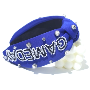 Close-up of royal blue fabric headband with beaded GAMEDAY lettering and rhinestones