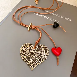 Vintage gold hollow heart pendant necklace with brown leather cord and colorful beads