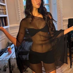 Detail view of transparent black mesh cover up top over bikini on female model