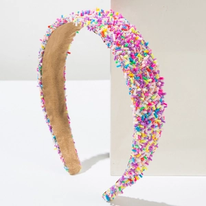 Detailed macro view of colorful sprinkle patterns on this wide minimalist headband