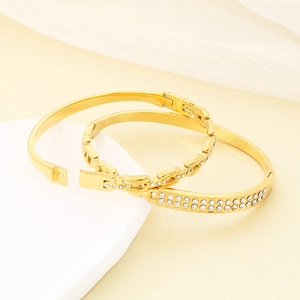 Luxury gold chain bracelet set with sparkling crystals on minimalist display