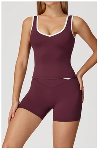 Detail of burgundy yoga set with white contrast trim and V-neck slim fit design