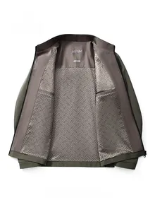 Detail of khaki men's jacket interior with geometric pattern lining and inner pocket