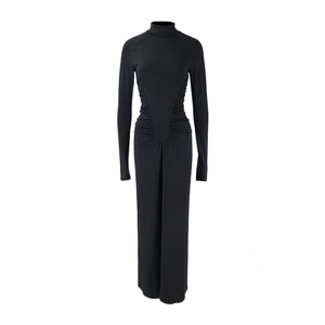 Detail view of the elegant ruched waist design on this slim black turtleneck maxi dress