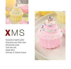 Macro detail of cupcake-shaped Christmas ornaments in pastel pink and yellow with icing