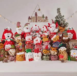 Detail of fabric Christmas gift bags featuring Santa, snowman, and reindeer characters