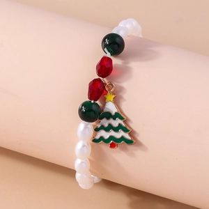 Detailed view of a Christmas beaded bracelet with festive tree charm and colorful pearls