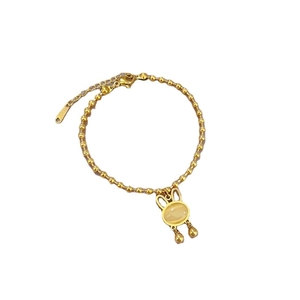 Golden titanium steel beaded bracelet featuring a rabbit pendant and cat eye stone