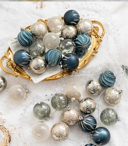 Detail of assorted blue and gold 6cm Christmas ornaments on an elegant tray