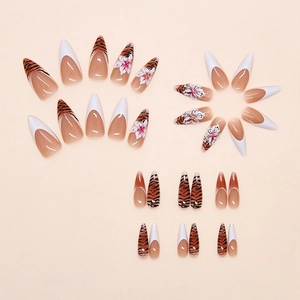 Detail of press-on nails featuring zebra print, French tips, and 3D floral designs
