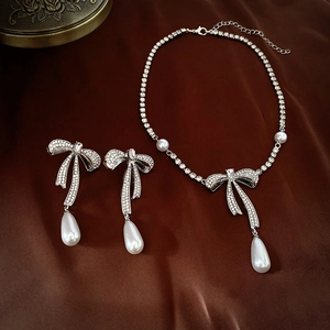 Elegant silver bow jewelry set with crystal necklace and teardrop pearl earrings