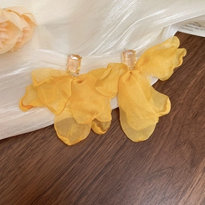 Bright yellow floral stud earrings featuring layered sheer fabric petals and clear crystals