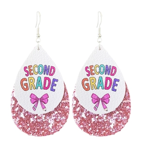 Detailed close-up of teardrop leather earrings with Second Grade text and pink glitter base