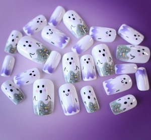 Detail of Halloween ghost press-on nails with purple gradient design and silver glitter