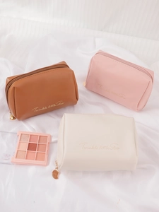 Detail of PU leather makeup bags with moon zippers in brown, pink, and cream colors