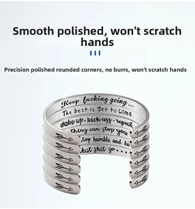 Macro shot of silver stainless steel cuff bracelets with engraved inspirational quotes