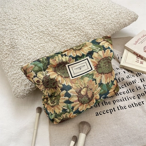 Detail of sunflower jacquard fabric and Pleasant Time woven label on the cosmetic bag