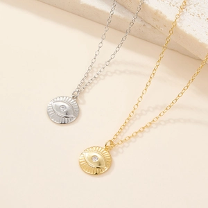 Detailed view of gold and silver S925 sterling silver necklaces with evil eye pendants