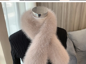 Close-up of thick faux fox fur scarf in soft pink, showing plush texture on a mannequin