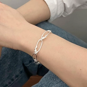 Chic S925 sterling silver chain bracelet with twisted oval links worn on a female wrist