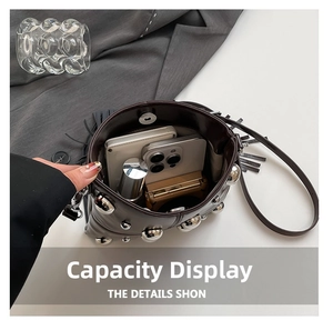 Detail view of the brown bucket bag interior showing capacity for phone and cosmetics