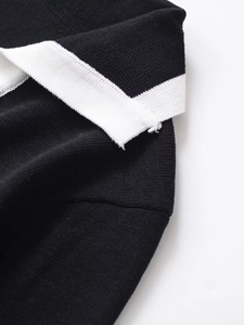 Detailed macro view of black high-density knit fabric with white contrast trim
