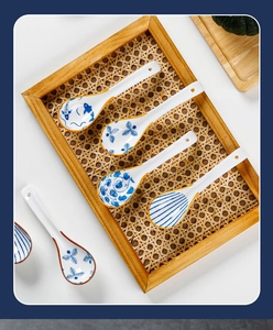 Top view of four Japanese ceramic soup spoons with blue and white floral patterns