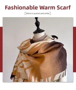 Close-up of caramel and dark coffee color blocked cashmere scarf with abstract animal patterns