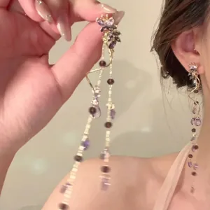 Elegant butterfly tassel earrings with purple glass beads and long golden chains