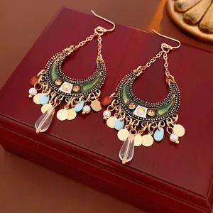 Bohemian moon drop earrings with rhinestones and colorful tassel pendants on wood box