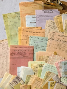 Flat lay of vintage scrapbooking paper set with antique receipts and metal clip detail