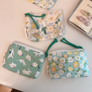 Detail of floral and cat print cotton coin purses with zipper and cotton rope handles