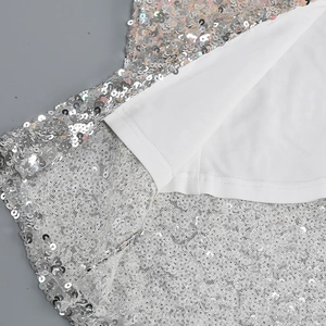 Close-up of high-density silver sequins and fine stitching on a V-neck party dress