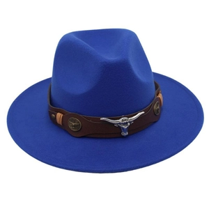 Detail of royal blue felt fedora featuring a leather band and silver bull head emblem