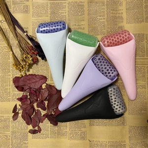 Detail showing seven colorful ice rollers for facial massage on a vintage background