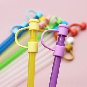 Detail of yellow and purple silicone straw caps with flexible leak-proof covers