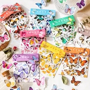 Detail of vintage butterfly stickers for DIY scrapbooking with floral backgrounds