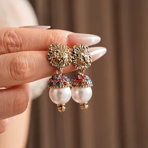 Vintage gold lion head earrings with rainbow crystals and large white pearls