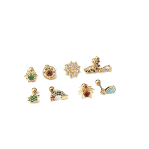 Set of 8 gold stainless steel ear studs with colorful zircon stones on white background