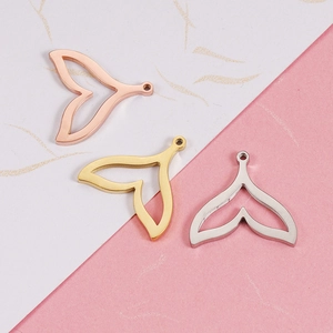 Detailed view of cutout mermaid tail pendants in gold, silver, and rose gold finishes