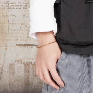 Detail of 18k gold plated stainless steel O-chain bracelet worn on a model wrist