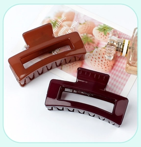 Detailed view of brown and dark red rectangular hollow hair claw clips for women