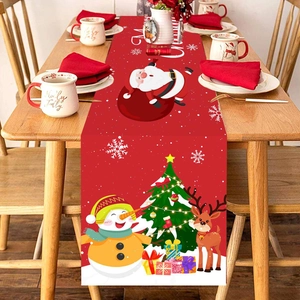 Christmas table runner with snowman and Santa patterns on a red festive fabric background