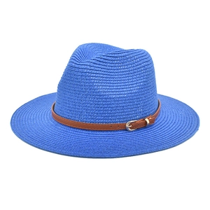 Close-up of blue straw Panama hat with fine woven texture and brown leather belt
