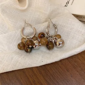 Silver hoop earrings with brown resin beads and gradient accents in Y2K style