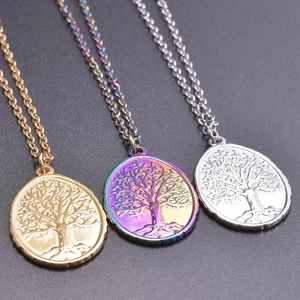 Three stainless steel tree of life oval pendants in gold, rainbow, and silver finishes