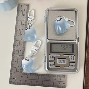 Three ghost charms on scale and ruler showing weight 13.22g and size details