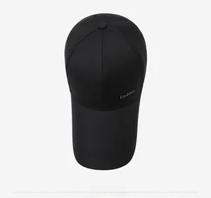 Detailed top view of a black baseball cap featuring a decorative fashion label on the side