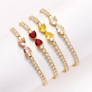 Macro view of colorful heart-shaped crystal tennis bracelets in gold plating