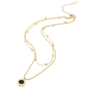 Double layered 18k gold titanium necklace featuring black and white shell pendant